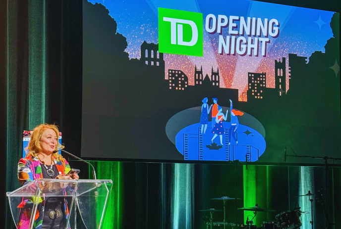 A speaker addresses the audience at the podium during the TD Opening Night event.