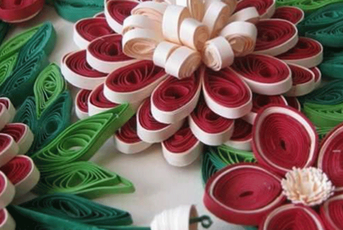Red, white and green paper twirled into flowers and leaves.