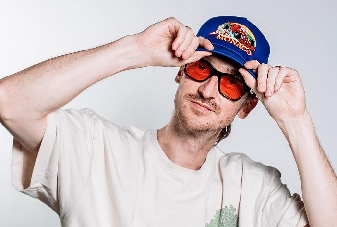 DJ Probcause with a blue cap and orange tinted sunglasses