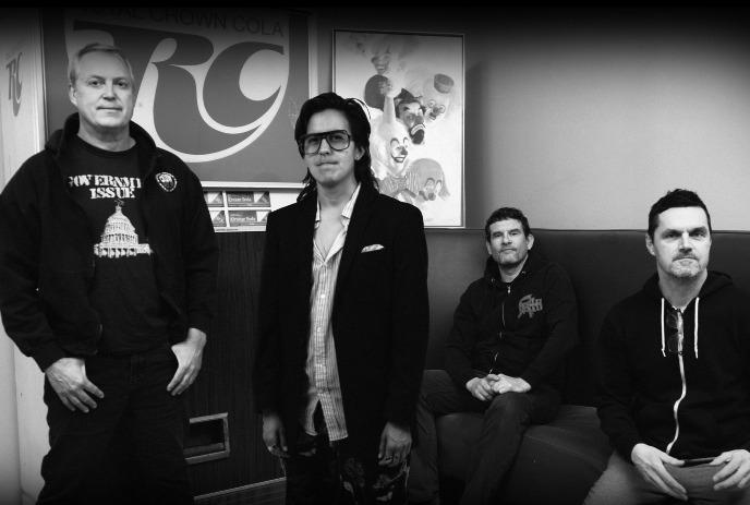 The band Propagandhi poses in front of an RC Cola sign in a black-and-white photo.