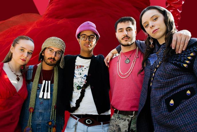 A microphone on stage with lights in the background.