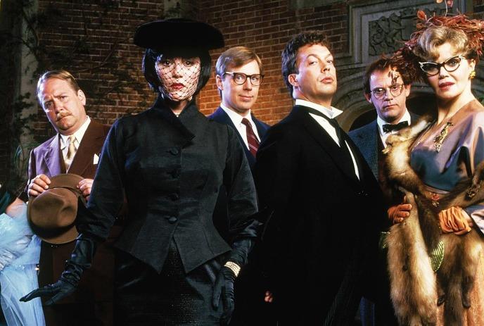 A number of people in fancy clothes looking at the camera.