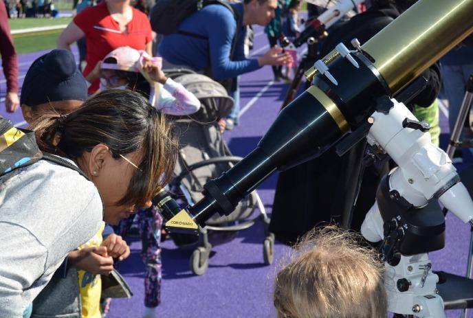 Kids looking through a telescope