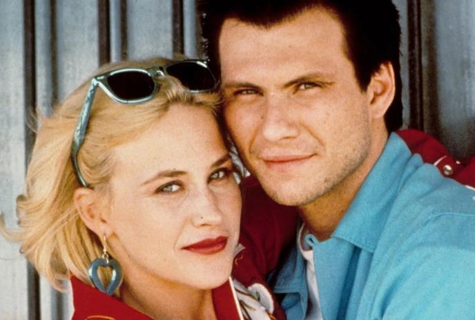 Annabella Sciorra and Ron Eldard as Donna and Michael in True Love (1989), posing closely together.