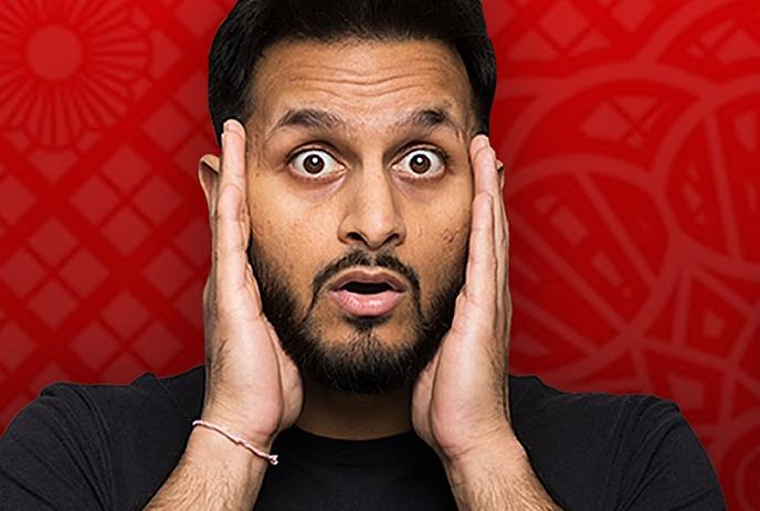 A person wearing a black shirt, hands placed on head, with a vibrant red geometric-patterned background.