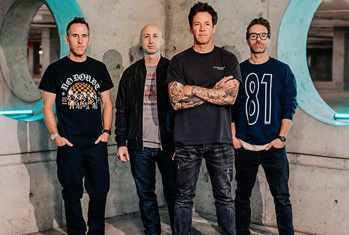 Members of the canadian band Simple Plan standing in a underground parking lot