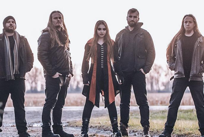 Solarus band stands outdoors, posing confidently with a blurred countryside landscape behind.