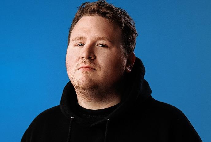 A face portrait of Brendan Sagalow with serious pensative expression, with a black background.
