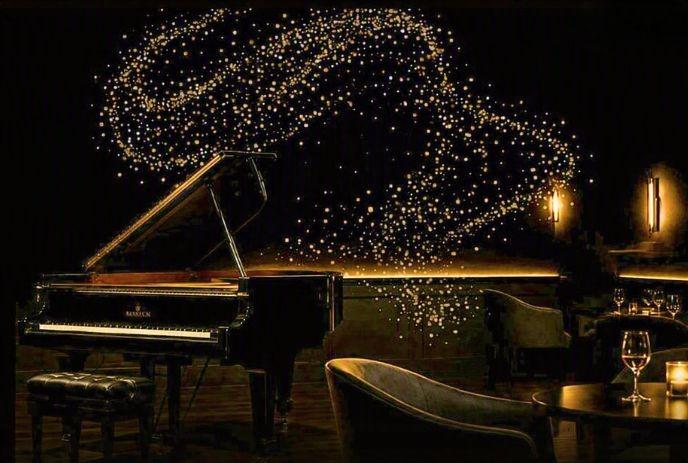 dimly lit lounge with grand piano and seating