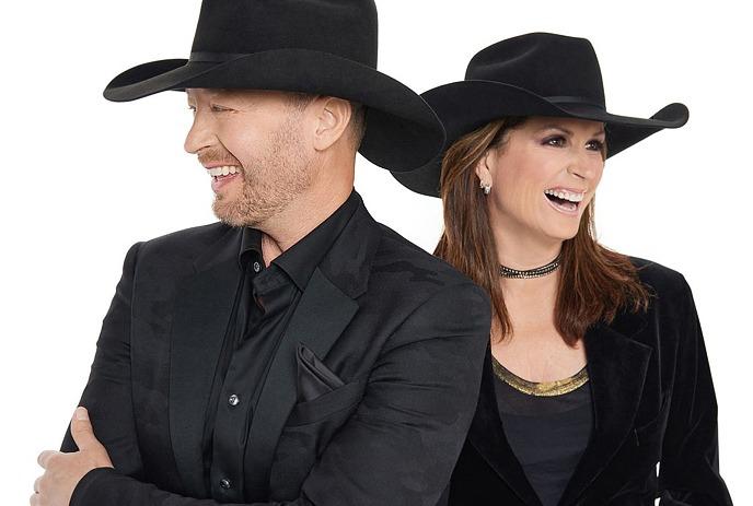 Musicians Terri Clark & Paul Brandt, both wearing black cowboy hats