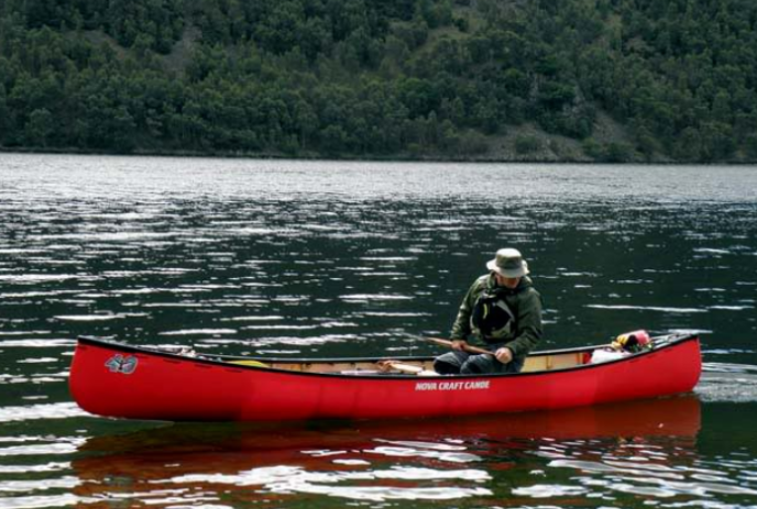 Person in a red canoe out on the water.