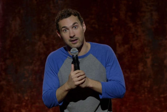 Mark Normand holding a microphone.