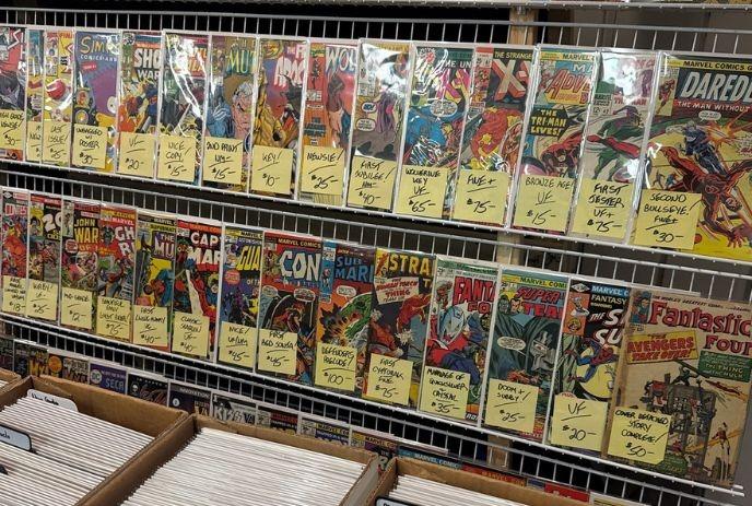 Vintage Marvel fiction comics displayed on shelves in protective covers.