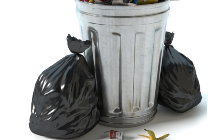 Silver garbage can with two full black garbage bags beside it.