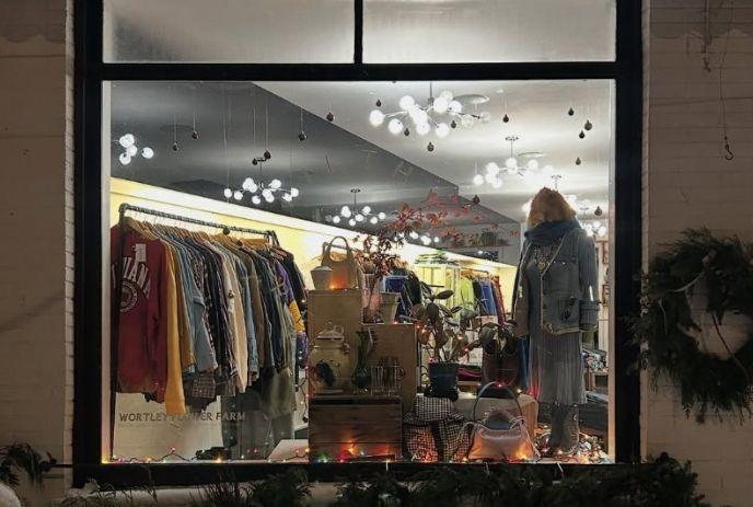 Vintage Store Day, a lively store window display with mannequins, clothing racks, and twinkling lights.
