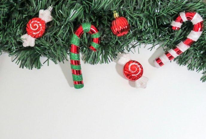 Festive garland with candy canes, peppermints, and a red ornament bring vibrant Christmas cheer.