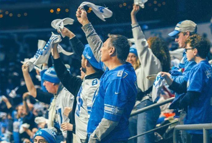 Fans in blue cheer, wave towels, and rally together in a stadium filled with team spirit and excitement.