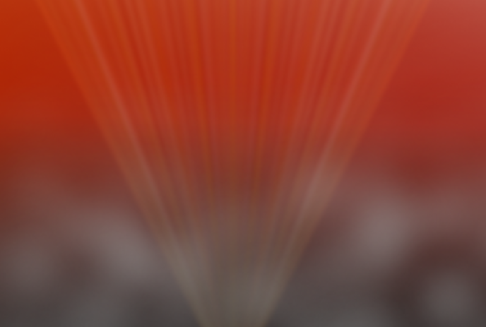 Ray of light spreading into a red and black background.