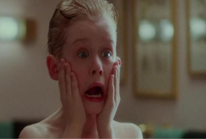 Young boy reacts hilariously after splashing his face with after shave.