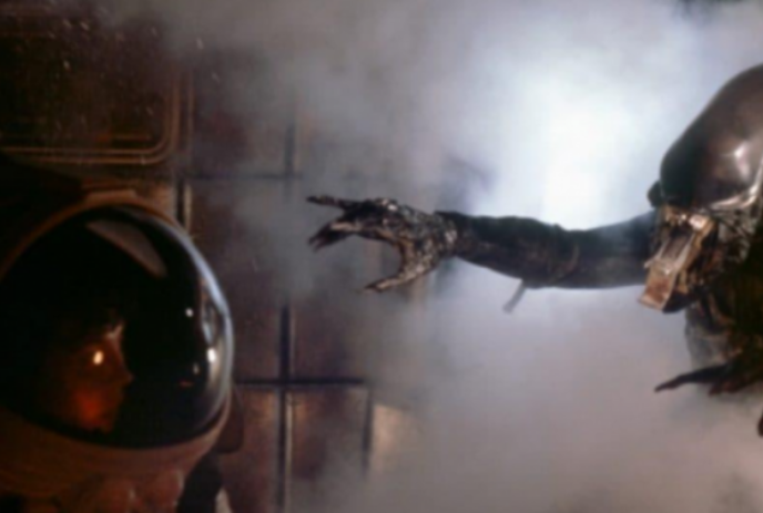 An alien reaching towards a person in a space suit.