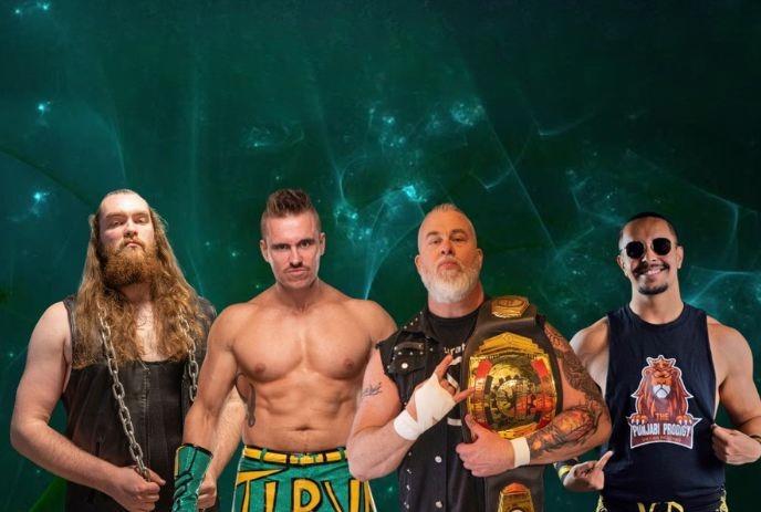 Four wrestlers pose in bold outfits, chains, belts, trunks, and attitude—against a moody green backdrop.