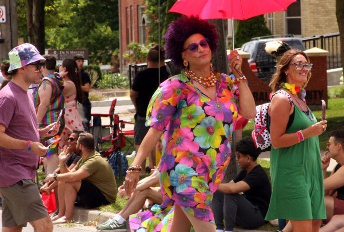 People enjoying the Pride London Summer Festival on a sunny summer day.