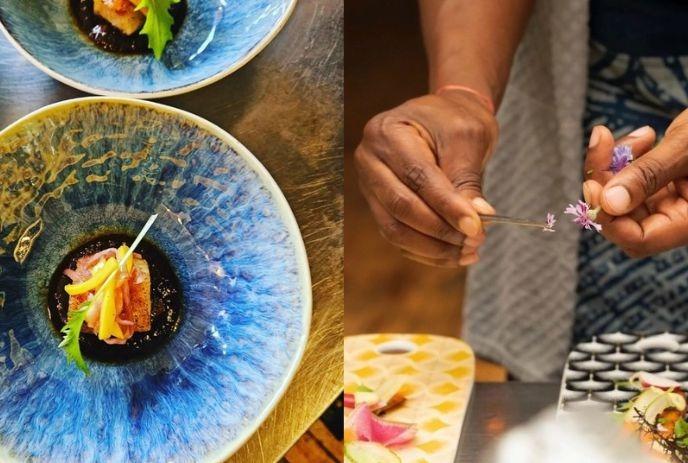 Two plates with artful food and hands placing flowers beside them showing careful fine dining style plating work.