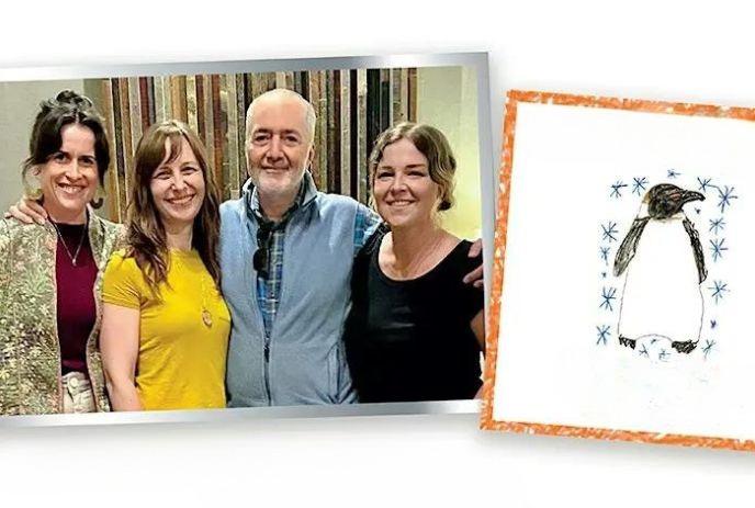 Four artists pose indoors beside childlike penguin drawing framed in orange.