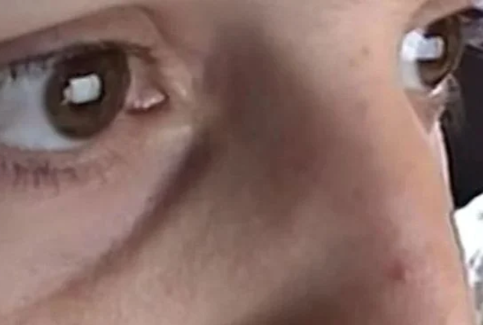 Close-up shot of a person's brown eyes looking straight ahead