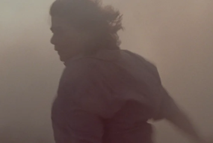 A person tries to walk in the middle of a sandstorm.