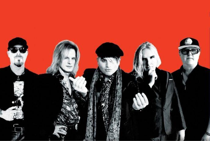 Five artists posing against vivid red backdrop.
