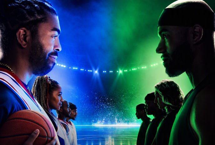 Basketball teams face off under blue and green arena lights, with a player holding a basketball.