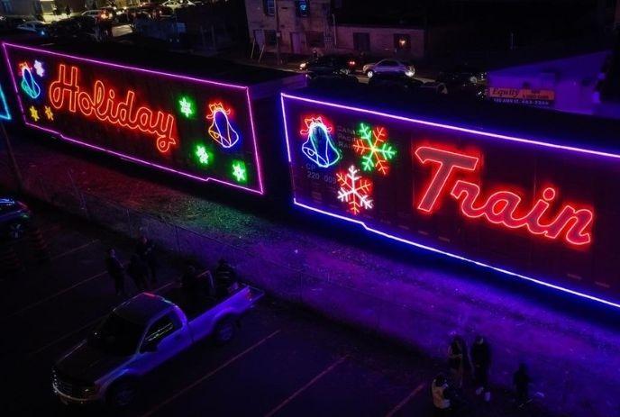 Outdoor brightly lit train stage at night.