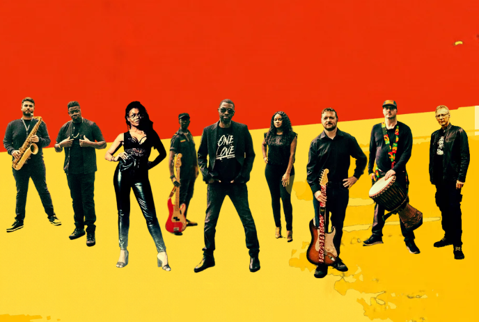 Large group of people wearing black stand together holding their instruments.
