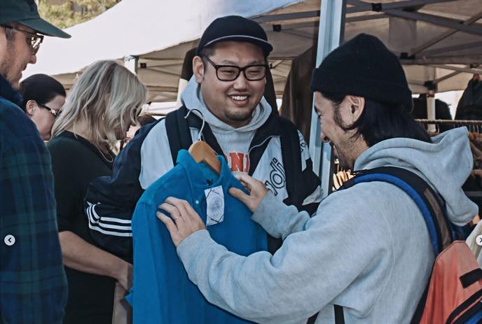 Males browsing vintage clothes at outdoor Vintage on the Block market in London, Ontario