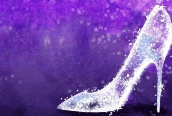 Sparkling glass slipper on a purple background with glittering lights and magical effects.