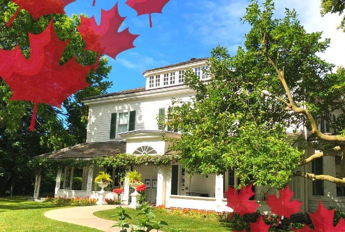 Eldon House from the outside on a sunny day, surrounded by red maple leaf graphics.