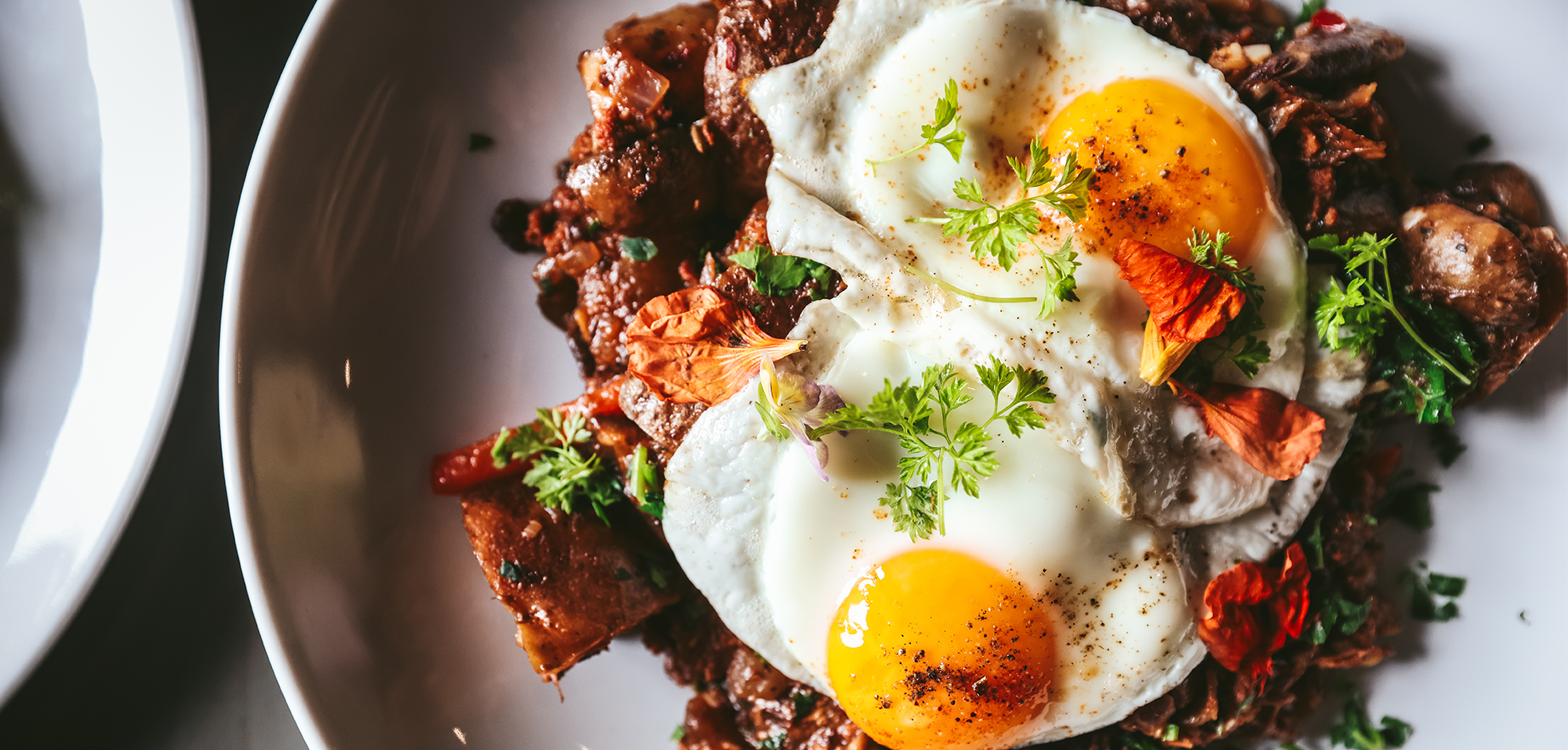 aerial view of a plate of sunny side up eggs over hash