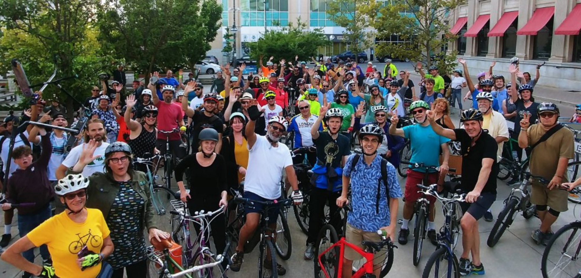 large group of bikers gather in Downtown London waving