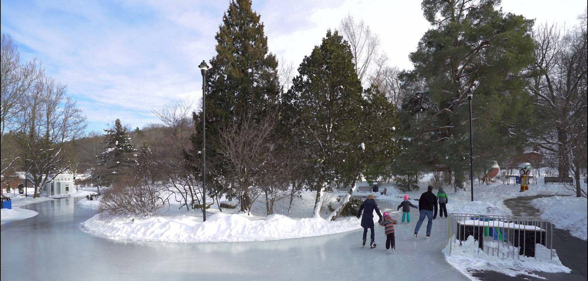 A family skating outdoors at Storybook Gardens in London, Ontario