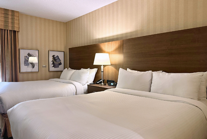 Inside a room with two beds and a lamp glowing softly.