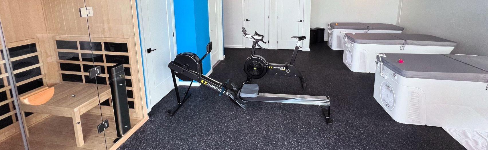 Interior of Fridge Recovery with exercise machines and plunge tubs.