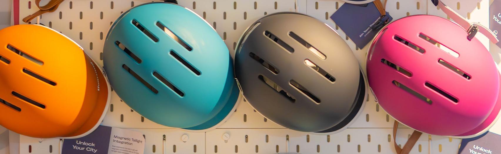 A group of colourful helmets on display at the Bicycle Cafe Service Centre