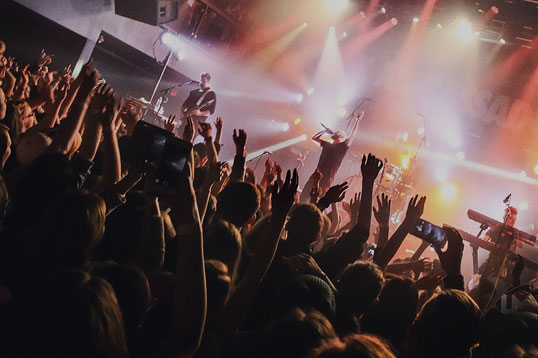 band playing on stage with audience