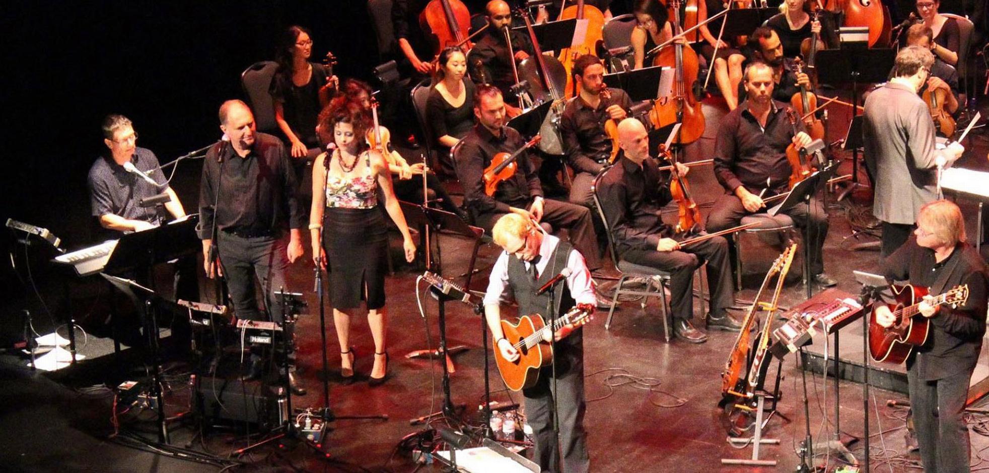 orchestra on stage playing musical instruments