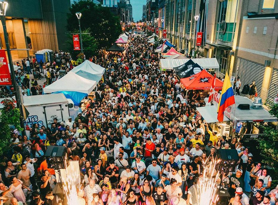 Aerial view of Dundas street in downtown London, Ontario filled with people attending an outdoor festival in the summer