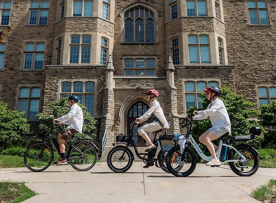 Three people riding their bikes on a path in London, Ontario