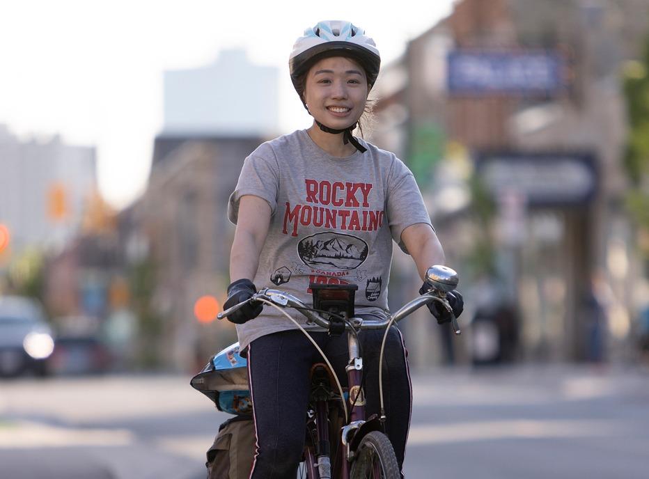 A cyclist riding on a path in downtown London, Ontario
