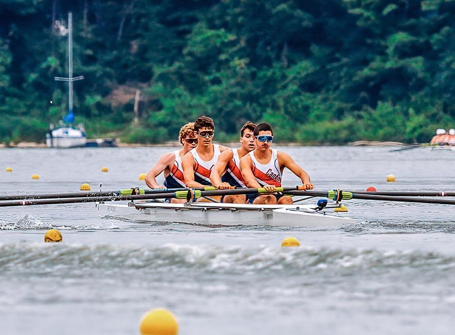 Four male rowers competing at Fanshawe Lake located in London, Ontario