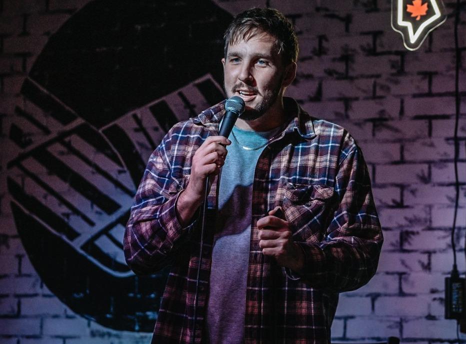 A comedian performing on stage at the Sorry! Comedy Fest held in London, Ontario
